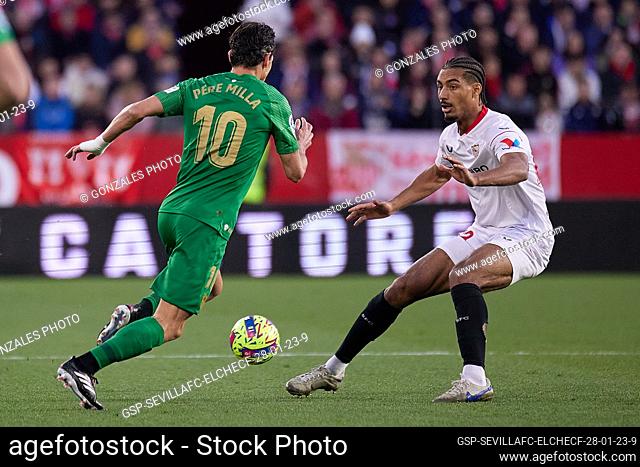 Seville, Spain. 28th, January 2023. Pere Milla (10) of Elche and Loic Bade (22) of Sevilla FC seen during the LaLiga Santander match between Sevilla FC and...