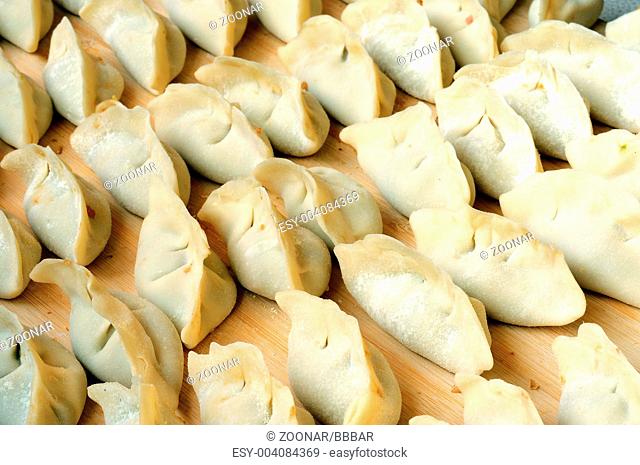 Chinese raw dumplings ready for being boiled