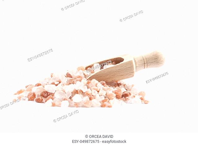 Himalayan Salt Raw Crystals Pile with Brown Wood Spice Scoop Isolated on White Background