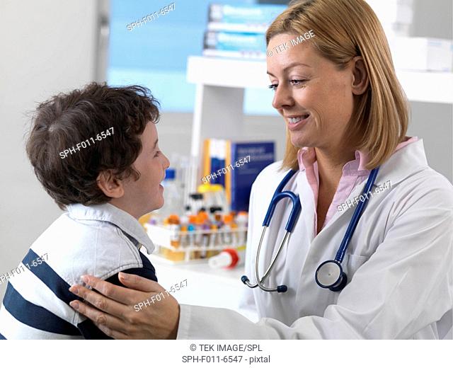 Doctor comforting a 5 year old boy in a clinic
