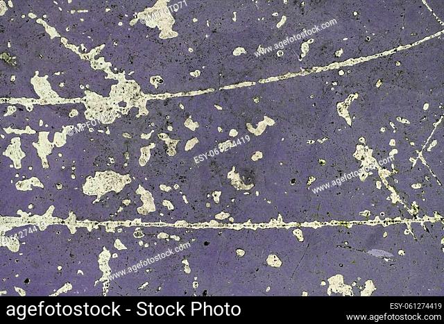 Detailed and colorful close up at cracked and peeling paint on concrete wall textures in high resolution