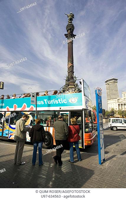 Tourist bus and Christopher Columbus monument. Barcelona, Spain