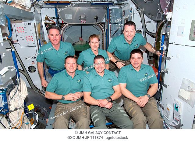 STS-130 crew members pose for an in-flight portrait in the Harmony node following a joint crew news conference with the Expedition 22 crew members while space...