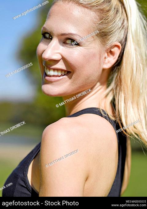 Portrait of happy young sportswoman