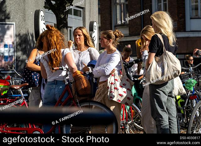 Copenhagen, Denmark, Young women hanging out in the afternoon on Vesterbrogade, a main shopping street