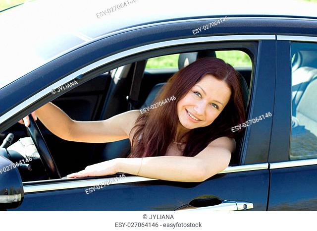 young woman smile in her new car