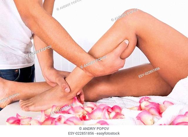Hand Massaging Leg In Spa