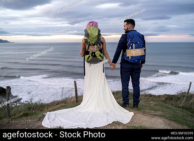 Bridal couple on viewpoint and ocean in the background