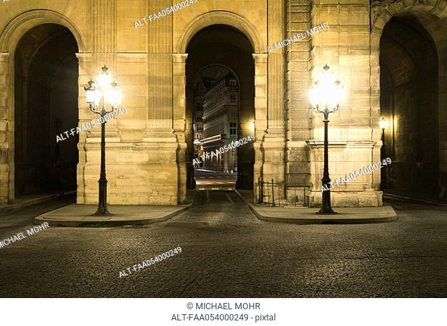 Arcade illuminated by street lamps, The Louvre, Paris, France