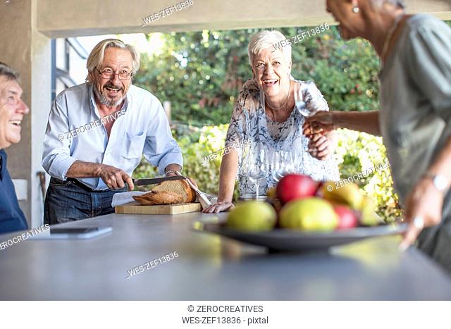 Two senior couples having fun together on terrace