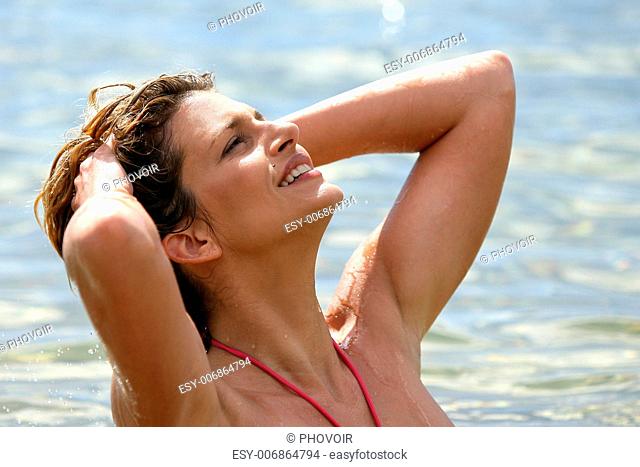 Blond woman posing on the beach