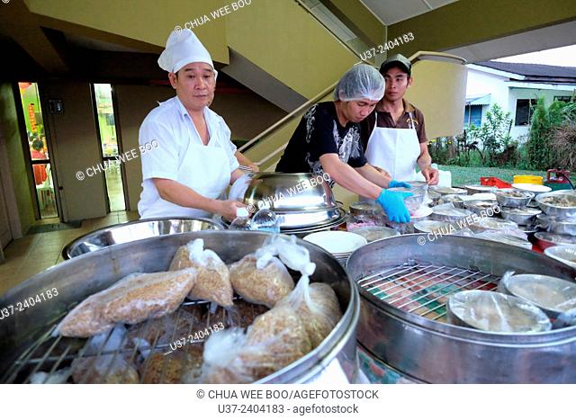 Cooks preparing The Chinese New Year dinner at Sungai Maong Community Hall, Kuching, Sarawak, Malaysia