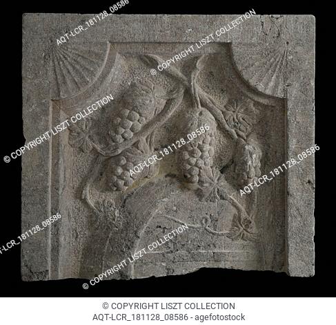 Fragment of facing brick with tons and bunches of grapes, faÃ§ade stone fragment sculpture sculpture material part stone