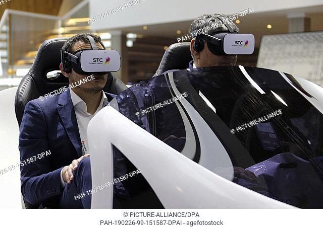 26 February 2019, Spain, Barcelona: Visitors using VR gears on the Saudi Telecom Company , during the Mobile World Congress 2019 in Barcelona