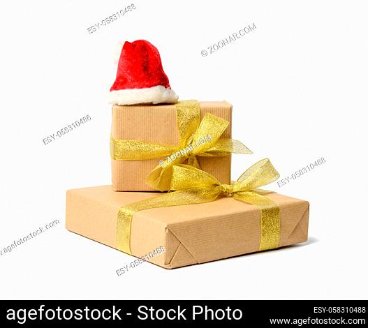 stack of gifts wrapped in brown kraft paper and tied with silk ribbon, boxes isolated on white background, element for designer