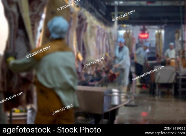 Blurred meat factory. Slaughterhouse. Butcher shop workers at work
