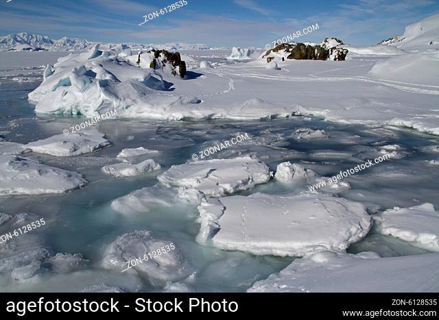 coastal strip of small icebergs and ice islands frozen Antarctic winter