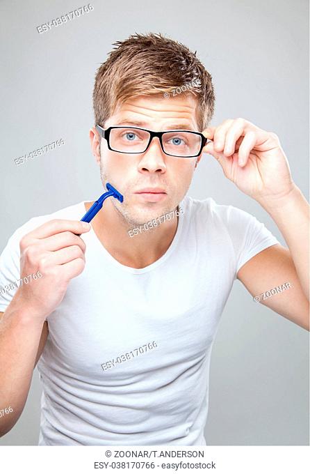 Portrait of a handsome man shaving