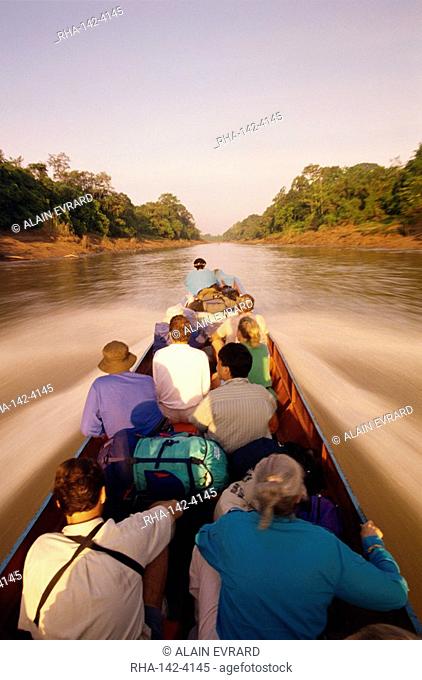 Tourists in longboat on a river in the Mulu National Park in Sarawak, Borneo, Malaysia, Southeast Asia, Asia
