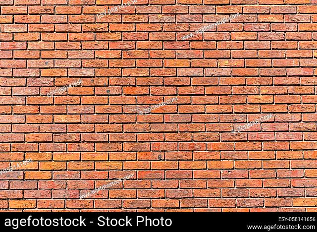Hintergrund von einer regelmäßigen roten Backsteinmauer