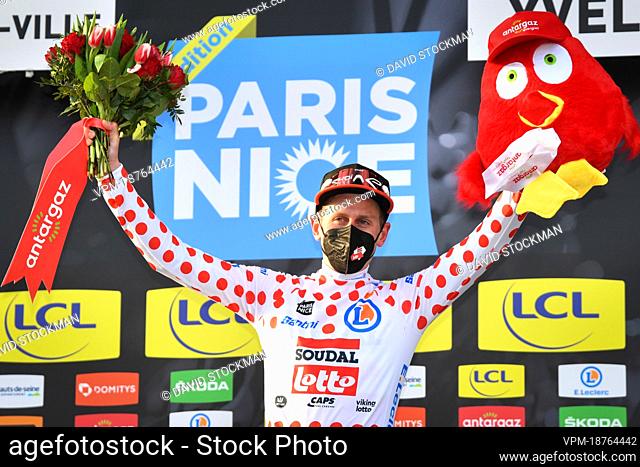 British Matthew Holmes of Lotto Soudal celebrates on the podium in the red polka-dot jersey for best climber after the first stage of 80th edition of the...