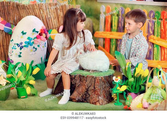 a fabulous farm boy and girl playing with white rabbit