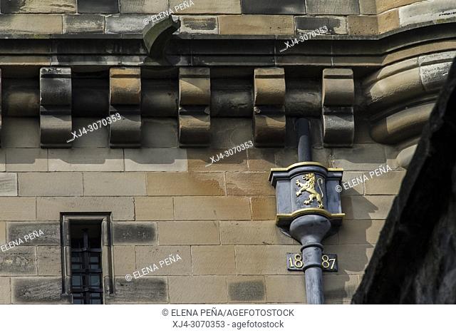 wall pipe decorated with golden lion, old castle, Edinburgh, Scotland