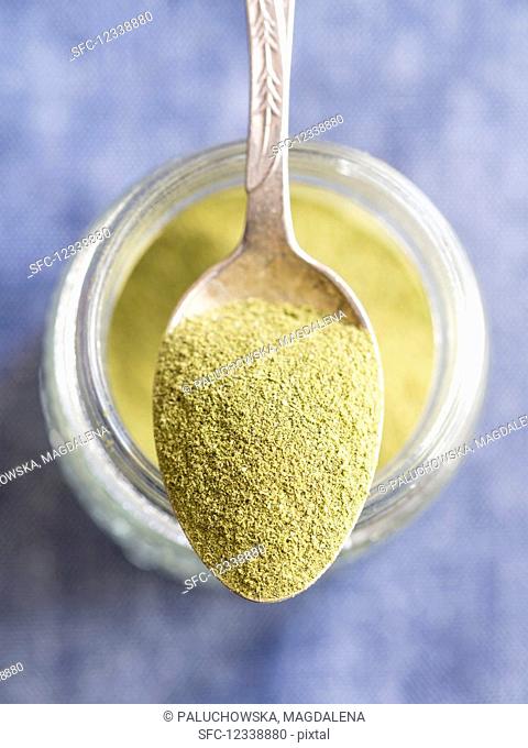 Moringa powder on a spoon