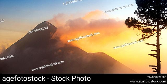 Fuego volcano (Volcan de Fuego) at sunset with smoke and cloud seen from Acatenango volcano