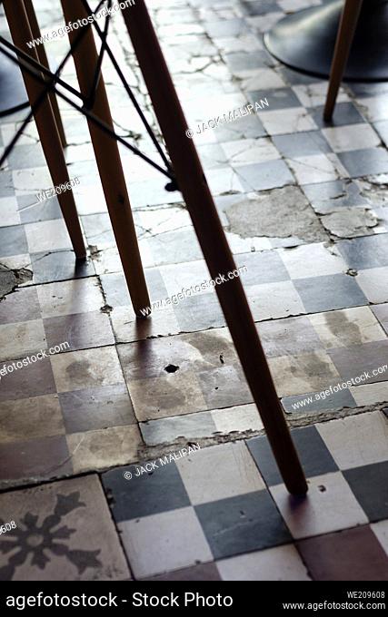 traditional design old broken floor tiles detail in trendy Ibiza cafe interior
