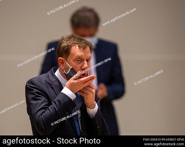 09 April 2020, Saxony, Dresden: Michael Kretschmer (CDU), Prime Minister of Saxony, gesticulates during a special session of the Saxon State Parliament in the...
