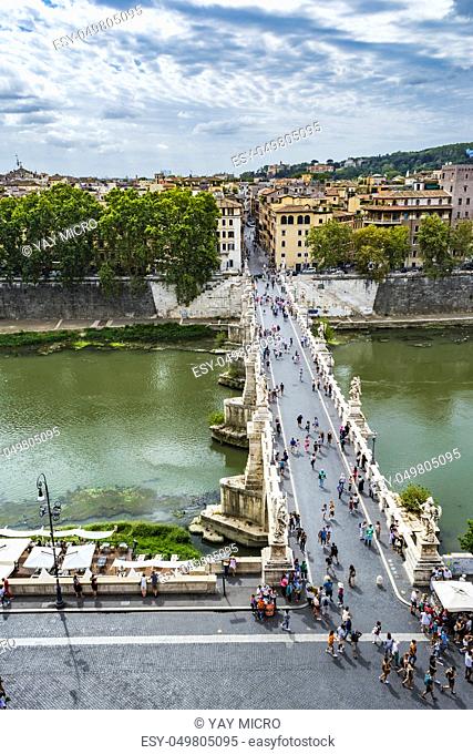 View of people walk on St Angel Bridge (Ponte Sant' Angelo) from Castel Sant'Angelo (Castle of Holy Angel) in Rome city