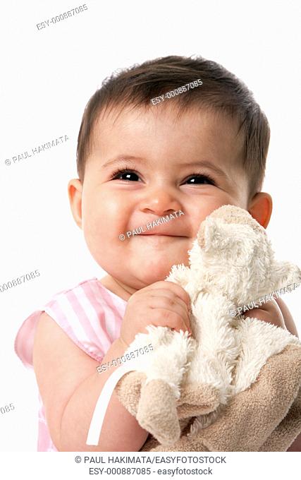 Beautiful happy cute baby girl smiling face with security blanket toy, isolated