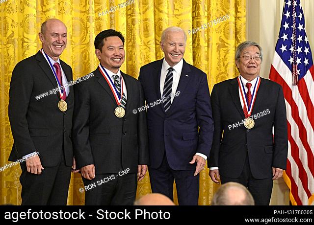 United States President Joe Biden poses for a photo with the team of Eric Swanson, David Huang and James Fujimoto after awarding them the National Medal of...