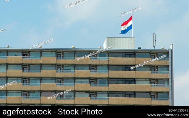 LEEUWARDEN, FRIESLAND, HOLLAND-APRIL 30: Dutch flag on top of a block of flats against the blue sky on Queen's Day on April 30, 2012 at Leeuwarden, Friesland
