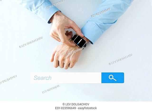 business, technology, and people concept - close up of male hands setting smart watch with web browser empty search bar on screen