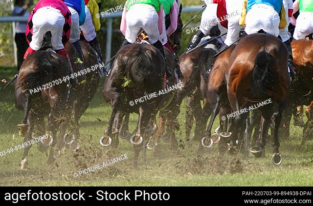 03 July 2022, Hamburg: Horse racing: Gallop, 153rd German Derby at the Horner racecourse. The participants of the German Derby run past the grandstand