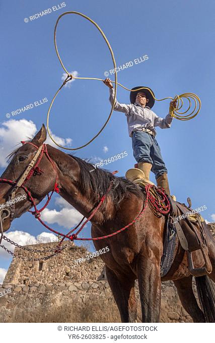 A Mexican charro or cowboy practices roping skills on his horse before a Charreada competition at a hacienda ranch in Alcocer, Mexico