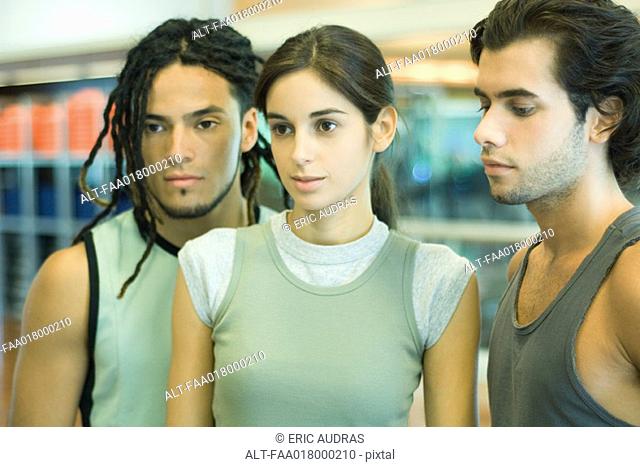 Three young adults in exercise clothes, portrait
