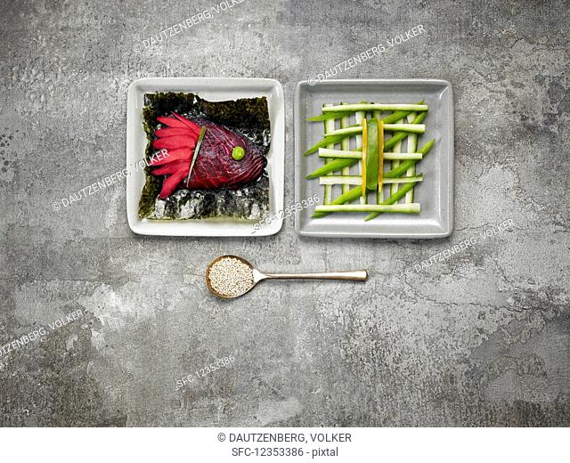 Ginger and smoked salmon coloured with beetroot juice, nori leaves and cucumber sticks