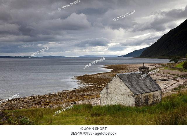 a weathered house at the water's edge, ardnamurchan argyl scotland