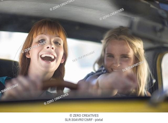Women having fun driving a car