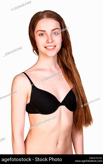 Smiling woman with perfect body posing in black underwear isolated on white background