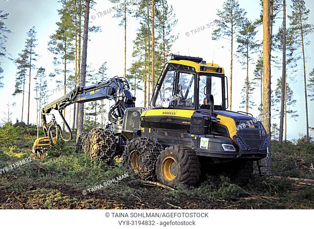 Salo, Finland - November 18, 2018: Logging site in Finnish pine forest on a day of autumn with Ponsse Ergo forest harvester. Filters applied