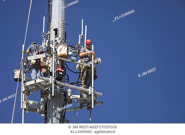Detroit, Michigan - Workers install equipment on a cell phone communications tower for T-Mobile