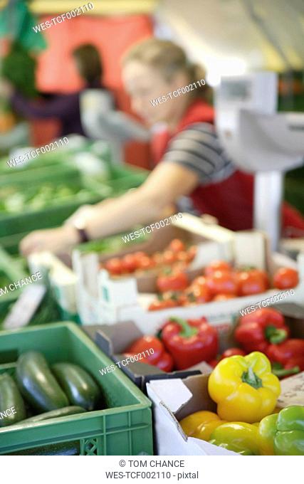 Germany, Upper Bavaria, Wolfratshausen, Woman buying vegetables from market