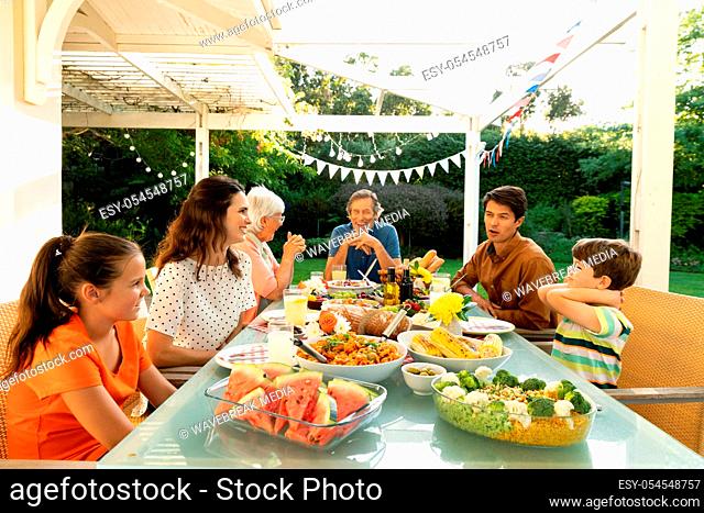 Family eating outside together in summer