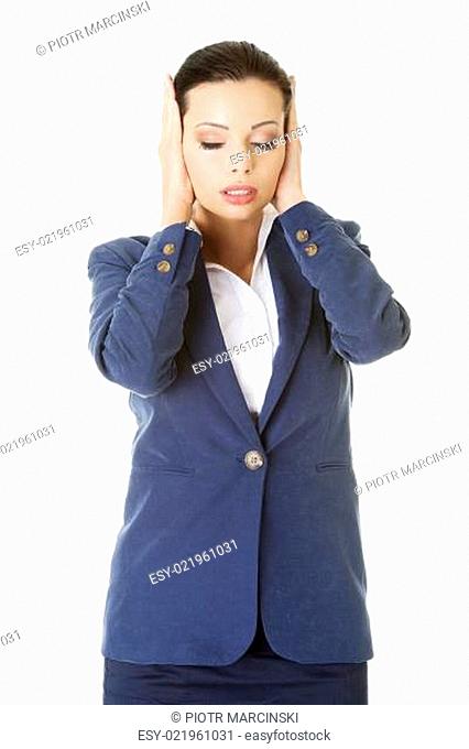 Attractive businesswoman covering her ears