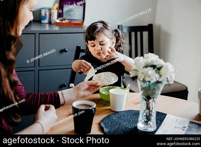 Mother with daughter at table