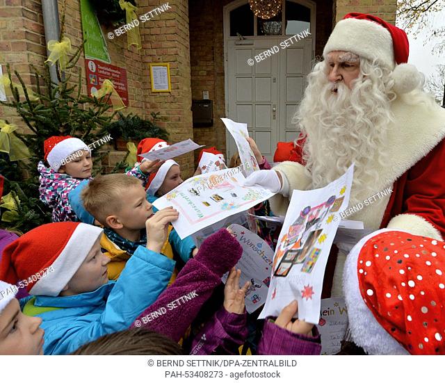 Santa accepts letters from Bredereiche Elementary School pupils for the opening of the Christmas Post Office in Himmelpfort, Germany, 06 November 2014